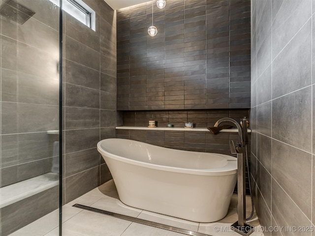 3661 S Lewis Ave, Tulsa, OK 74105 - bathroom featuring tile walls, a freestanding tub, and tile patterned flooring