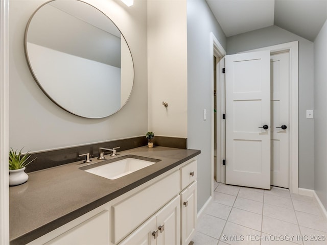 3661 S Lewis Ave, Tulsa, OK 74105 - bathroom featuring vanity, tile patterned floors, and vaulted ceiling