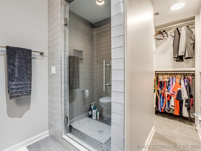 3661 S Lewis Ave, Tulsa, OK 74105 - full bathroom with a stall shower, tile patterned flooring, and a spacious closet