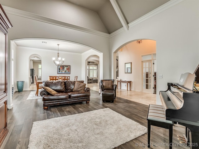 3661 S Lewis Ave, Tulsa, OK 74105 - living area with arched walkways, a chandelier, wood finished floors, and high vaulted ceiling