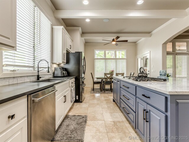3661 S Lewis Ave, Tulsa, OK 74105 - kitchen with stainless steel appliances, white cabinets, beam ceiling, ceiling fan, and gray cabinets