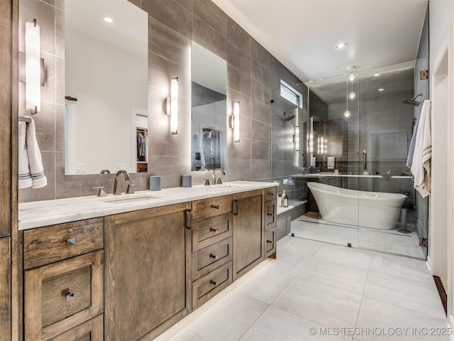 3661 S Lewis Ave, Tulsa, OK 74105 - full bathroom with tile walls, double vanity, tile patterned floors, tiled shower, and a soaking tub