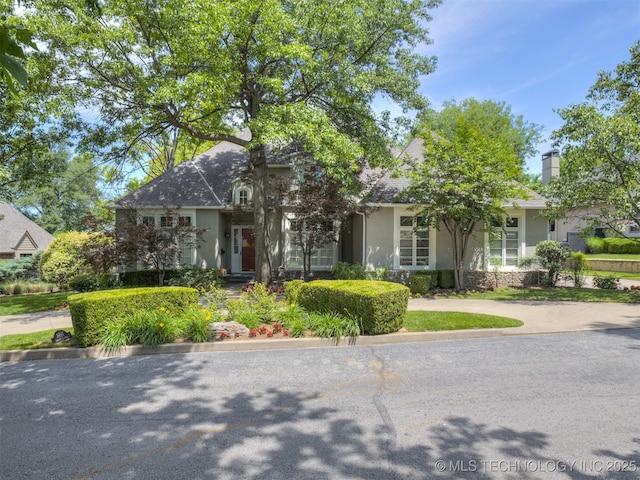 3661 S Lewis Ave, Tulsa, OK 74105 - obstructed view of property with stucco siding and a chimney