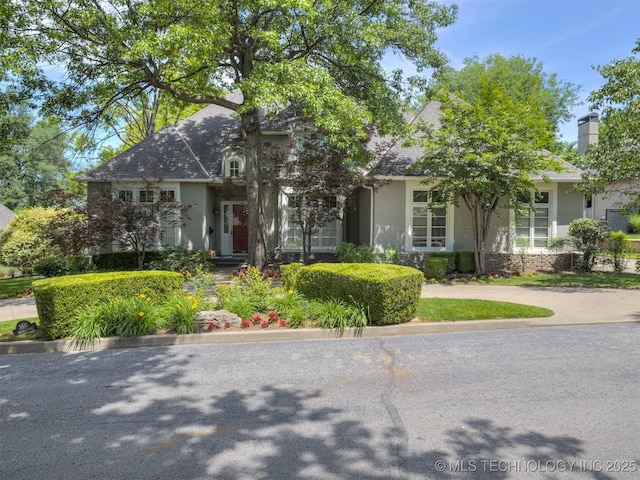 3661 S Lewis Ave, Tulsa, OK 74105 - view of property hidden behind natural elements featuring stucco siding and a chimney