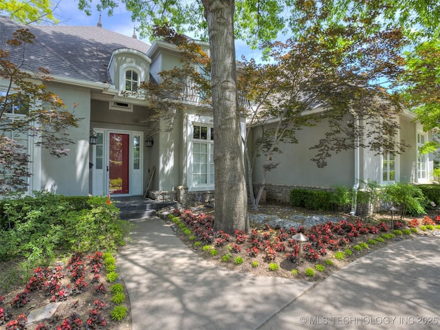 3661 S Lewis Ave, Tulsa, OK 74105 - view of exterior entry with stucco siding and a shingled roof