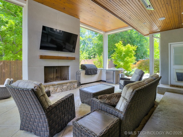 3661 S Lewis Ave, Tulsa, OK 74105 - view of patio / terrace featuring an outdoor living space with a fireplace and fence