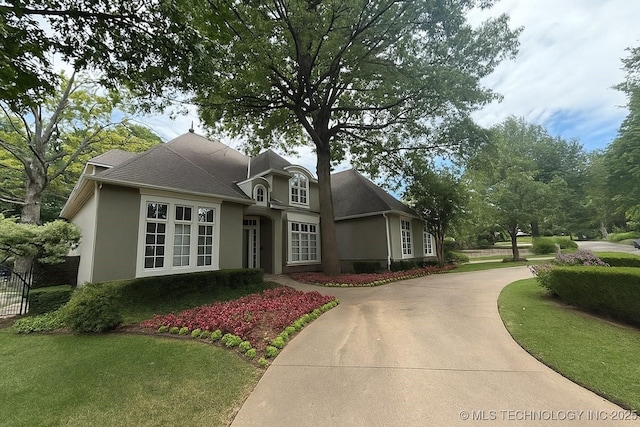 3661 S Lewis Ave, Tulsa, OK 74105 - view of front of property with stucco siding and concrete driveway