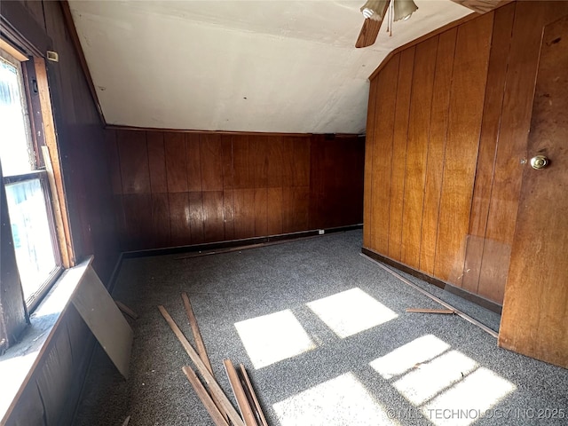 907 E 3rd St, Okmulgee, OK 74447 - additional living space with vaulted ceiling, plenty of natural light, wood walls, and ceiling fan