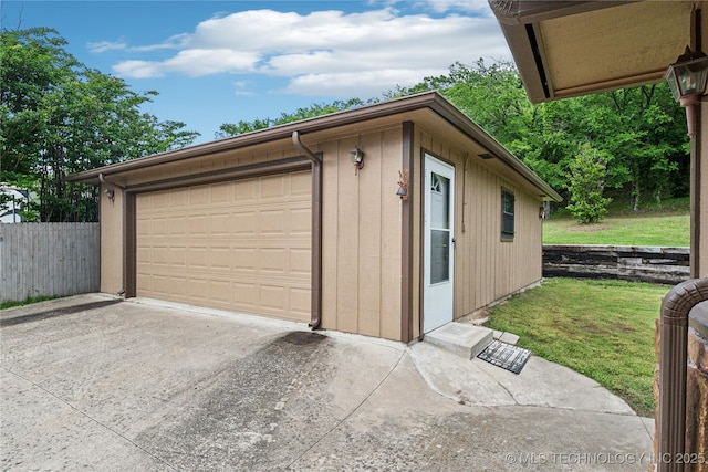 detached garage featuring fence