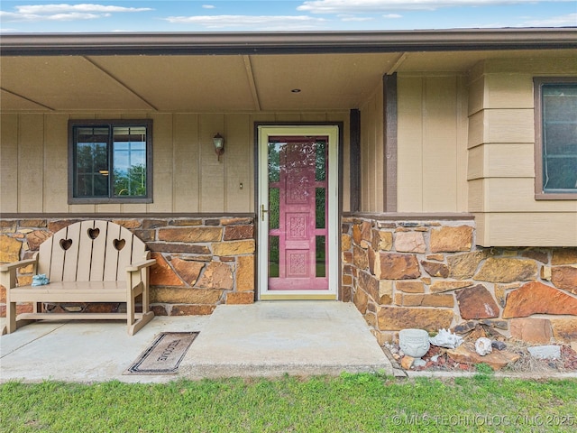 entrance to property featuring stone siding