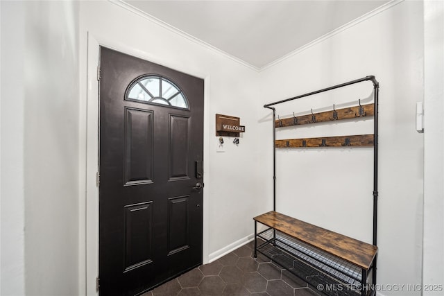 entrance foyer featuring dark tile patterned flooring, crown molding, and baseboards