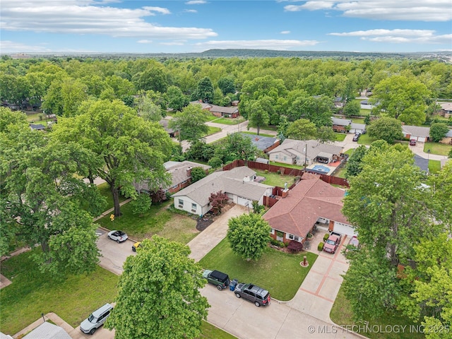 aerial view of residential area featuring a heavily wooded area