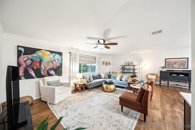 living area with a ceiling fan and wood finished floors