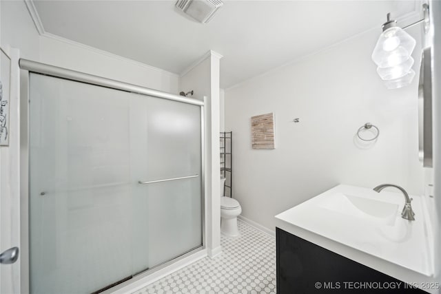 bathroom featuring a shower stall, ornamental molding, toilet, baseboards, and vanity