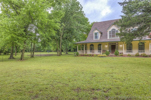 view of front facade with a porch, a front lawn, and a shingled roof