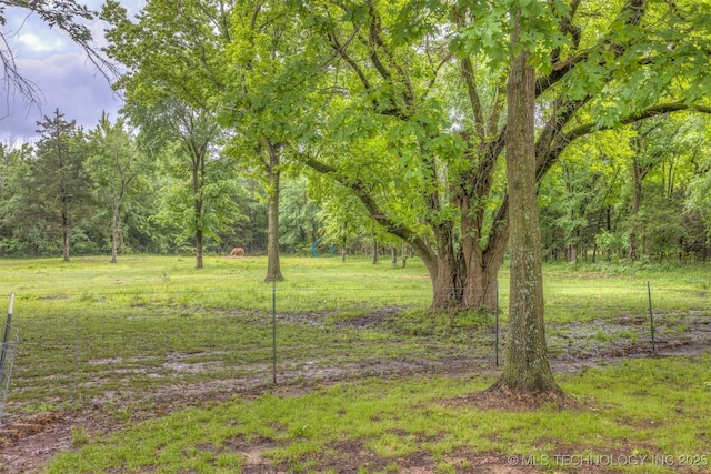 view of yard with a view of trees