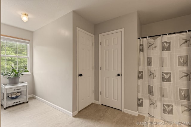 full bathroom with baseboards and a shower with curtain