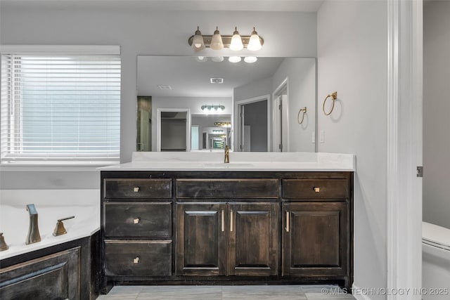 bathroom featuring vanity and toilet