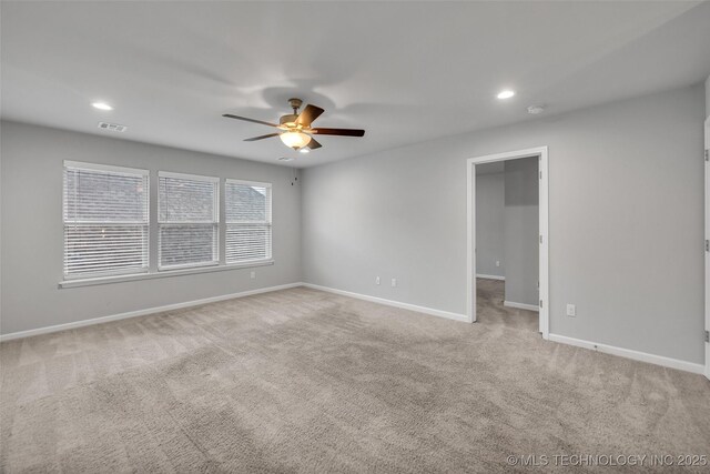 carpeted spare room featuring a ceiling fan, baseboards, recessed lighting, and a smoke detector
