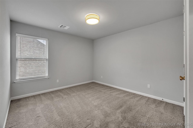 unfurnished room with carpet and baseboards