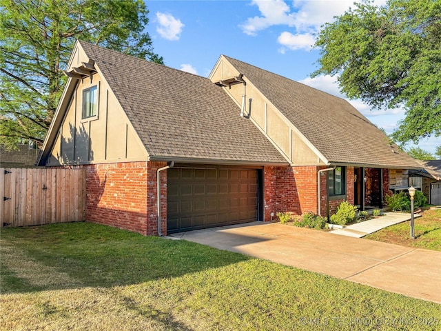 view of front of property featuring an attached garage, brick siding, stucco siding, and driveway