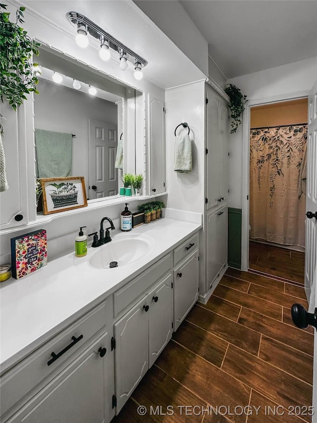 full bathroom with wood finished floors and vanity