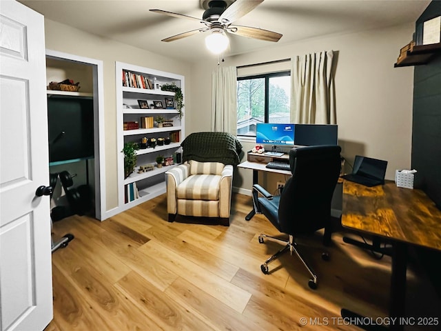 home office with ceiling fan, light wood-style flooring, and built in shelves