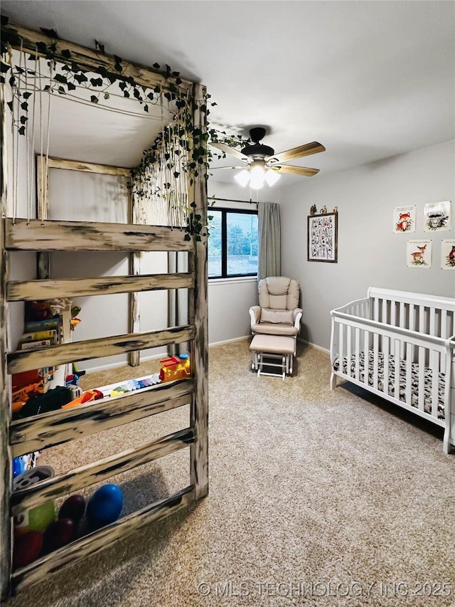 bedroom featuring carpet, a crib, and baseboards