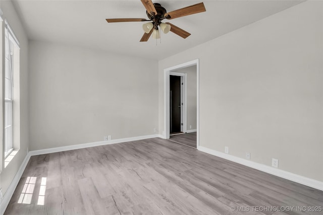 empty room featuring ceiling fan, wood finished floors, and baseboards