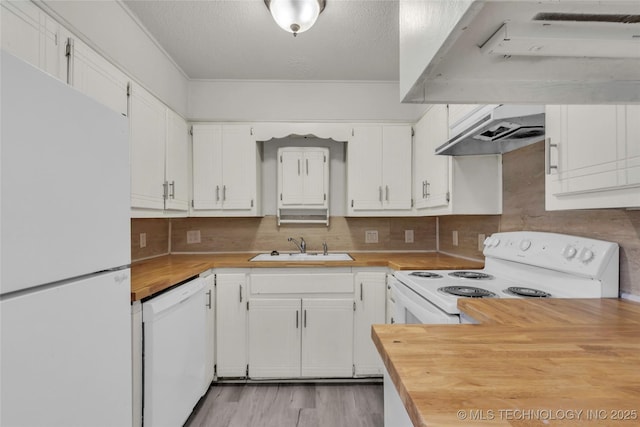 kitchen featuring white appliances, wood counters, a sink, a textured ceiling, and white cabinetry