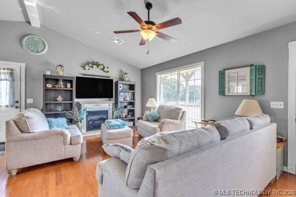10718 W 162nd St, Skiatook, OK 74070 - living room featuring lofted ceiling, a ceiling fan, and wood finished floors