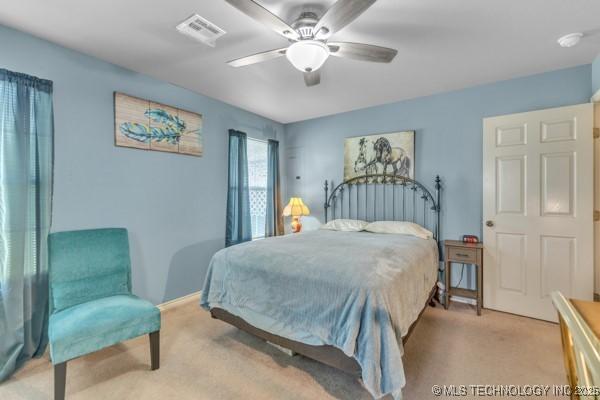 10718 W 162nd St, Skiatook, OK 74070 - bedroom with light colored carpet, ceiling fan, and baseboards