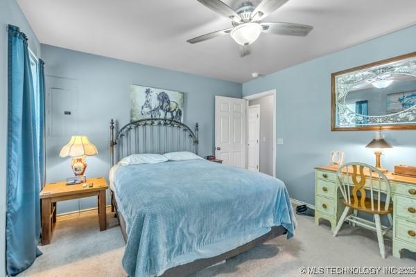 10718 W 162nd St, Skiatook, OK 74070 - carpeted bedroom with ceiling fan and baseboards