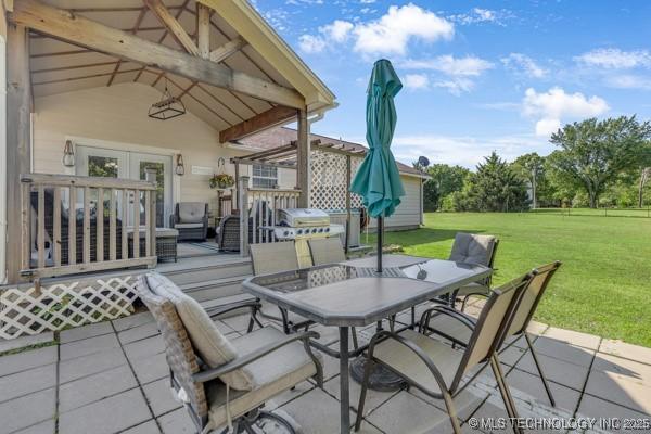 10718 W 162nd St, Skiatook, OK 74070 - view of patio featuring outdoor dining area and a wooden deck