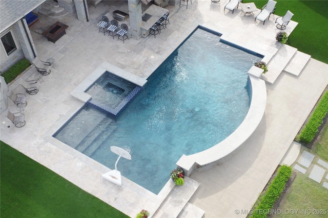 view of swimming pool featuring a patio area and a pool with connected hot tub