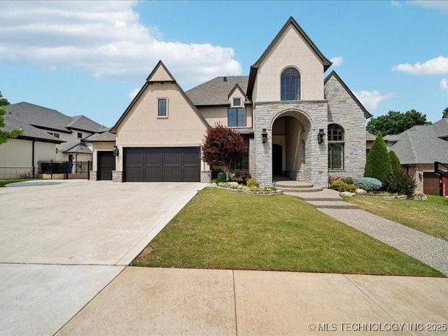 4301 S Mimosa Ave, Broken Arrow, OK 74011 - french provincial home featuring stone siding, a front yard, driveway, stucco siding, and a garage