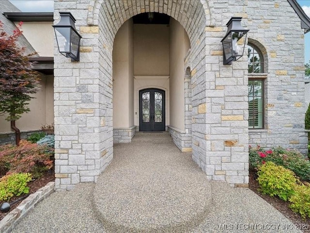 4301 S Mimosa Ave, Broken Arrow, OK 74011 - doorway to property with french doors, stucco siding, and stone siding