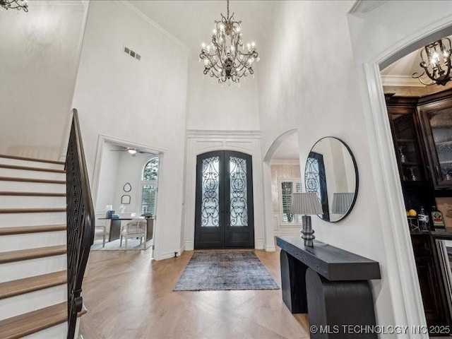 4301 S Mimosa Ave, Broken Arrow, OK 74011 - entryway featuring a chandelier, arched walkways, stairway, a high ceiling, and french doors