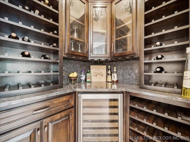 4301 S Mimosa Ave, Broken Arrow, OK 74011 - wine room featuring beverage cooler and a dry bar