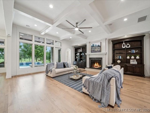 4301 S Mimosa Ave, Broken Arrow, OK 74011 - living room with a lit fireplace, coffered ceiling, light wood finished floors, a ceiling fan, and beam ceiling