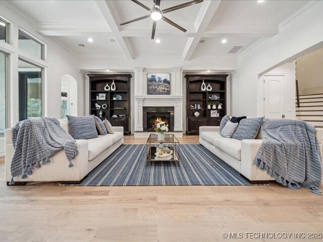 4301 S Mimosa Ave, Broken Arrow, OK 74011 - living room featuring wood finished floors, arched walkways, coffered ceiling, beamed ceiling, and ceiling fan