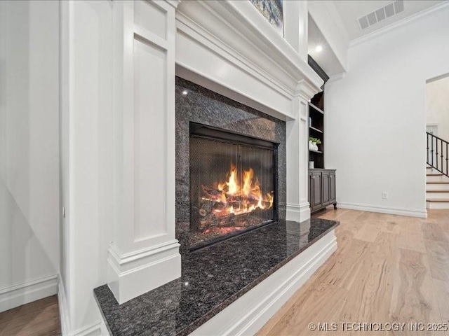 4301 S Mimosa Ave, Broken Arrow, OK 74011 - detailed view of a premium fireplace, wood finished floors, baseboards, and ornamental molding
