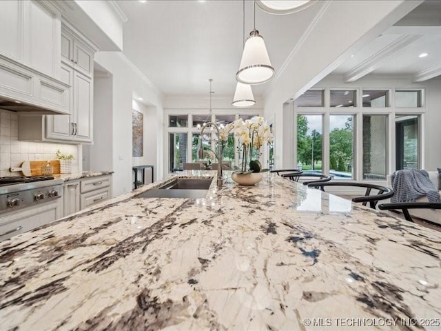 4301 S Mimosa Ave, Broken Arrow, OK 74011 - kitchen with a sink, ornamental molding, light stone countertops, tasteful backsplash, and pendant lighting