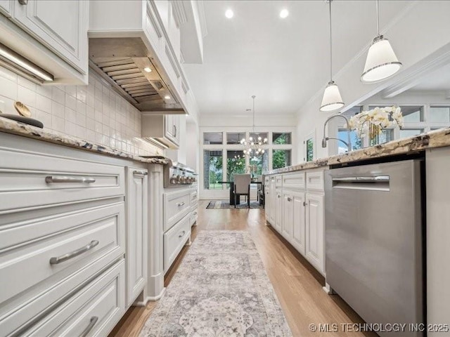 4301 S Mimosa Ave, Broken Arrow, OK 74011 - kitchen with stainless steel dishwasher, a chandelier, decorative backsplash, white cabinets, and light stone counters