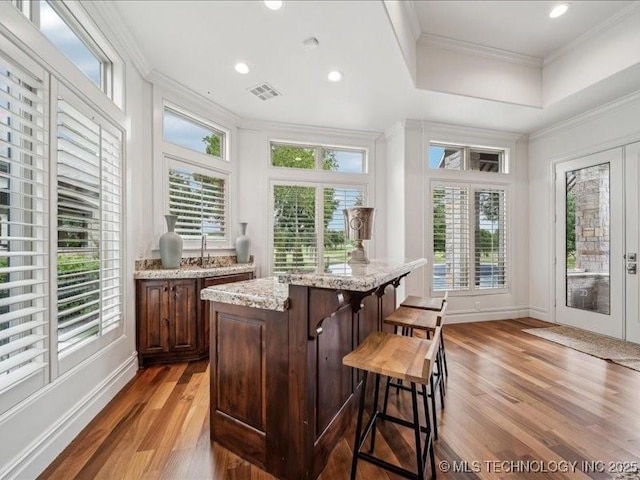 4301 S Mimosa Ave, Broken Arrow, OK 74011 - indoor wet bar with wood finished floors, ornamental molding, baseboards, recessed lighting, and a tray ceiling