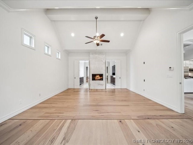 4301 S Mimosa Ave, Broken Arrow, OK 74011 - unfurnished living room with a ceiling fan, light wood-type flooring, beamed ceiling, baseboards, and high vaulted ceiling