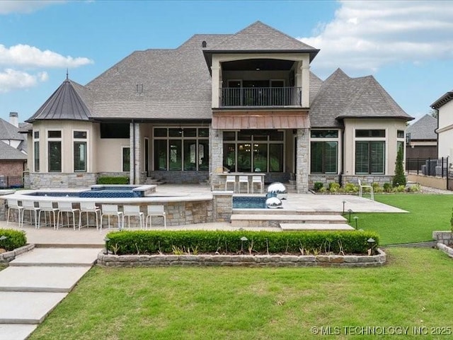 4301 S Mimosa Ave, Broken Arrow, OK 74011 - back of property with a balcony, stone siding, a patio area, roof with shingles, and stucco siding