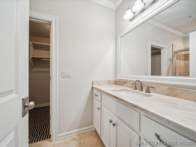 4301 S Mimosa Ave, Broken Arrow, OK 74011 - bathroom with vanity, a spacious closet, crown molding, a tile shower, and tile patterned floors
