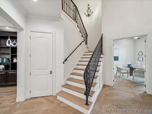 4301 S Mimosa Ave, Broken Arrow, OK 74011 - stairs featuring crown molding, a high ceiling, and baseboards