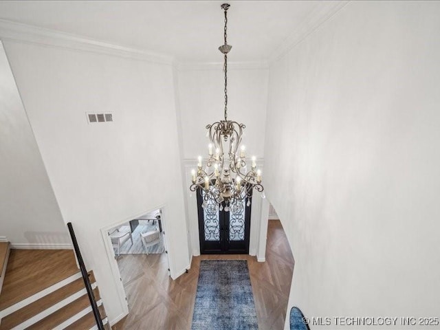 4301 S Mimosa Ave, Broken Arrow, OK 74011 - foyer entrance with a chandelier, ornamental molding, french doors, a towering ceiling, and baseboards